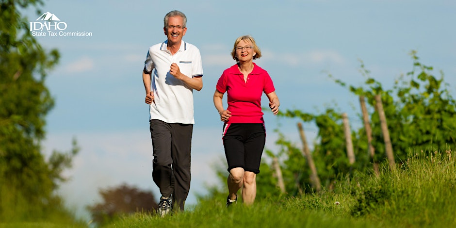 Retired couple jogging outdoors.